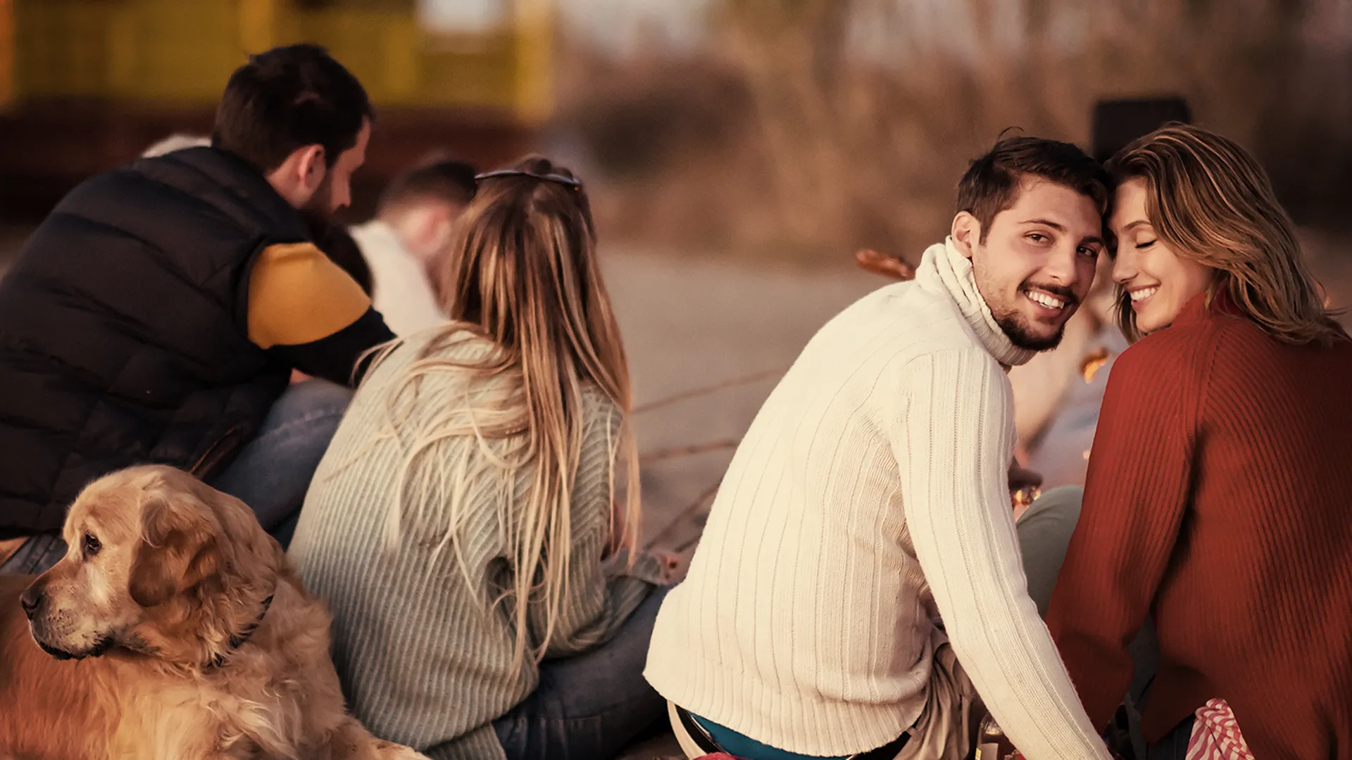 Smiling elderly man with a beard adjusting his watch while hiking, showcasing his vibrant and healthy smile in an outdoor setting, symbolizing an active lifestyle post full mouth reconstruction.